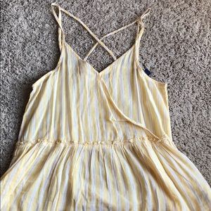Yellow stripe peplum tank with criss-cross straps